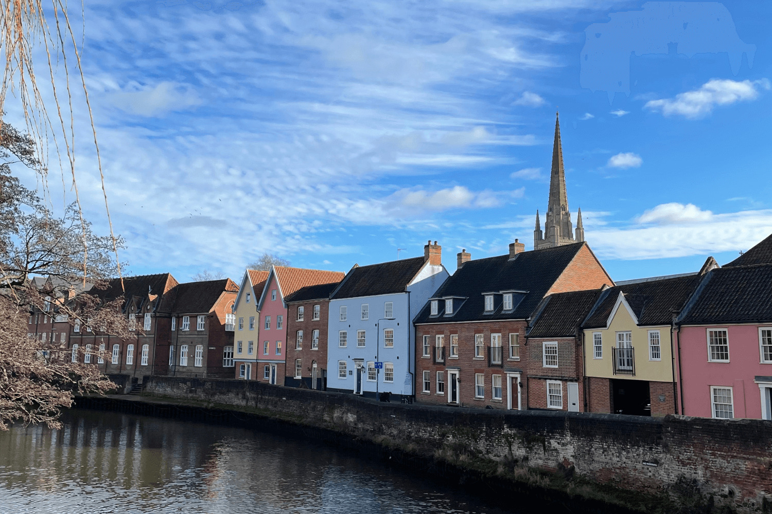 Norwich river scene with colourful houses and Norwich Cathedral in the background to illustrate Norwich networking