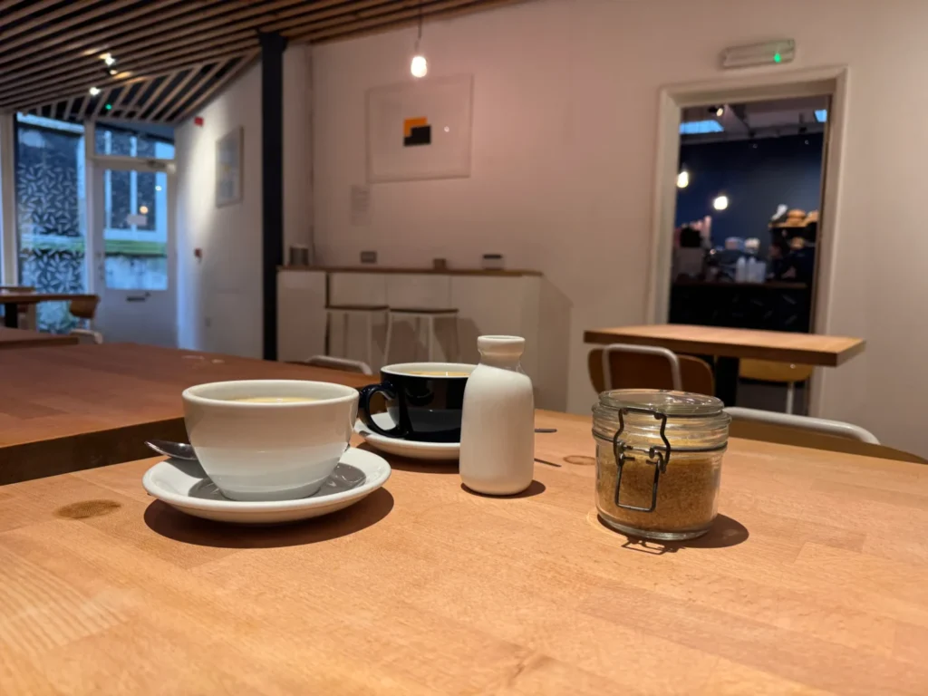 Two coffee cups on a table at Bread Source in Norwich