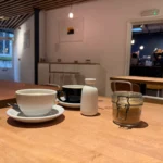Two coffee cups on a table at Bread Source in Norwich