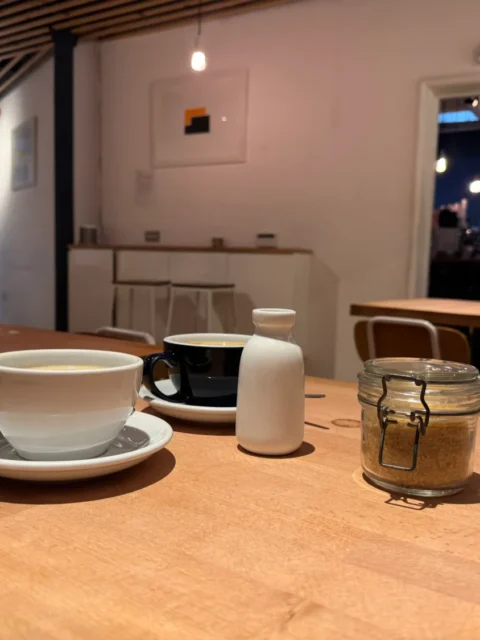 Two coffee cups on a table at Bread Source in Norwich