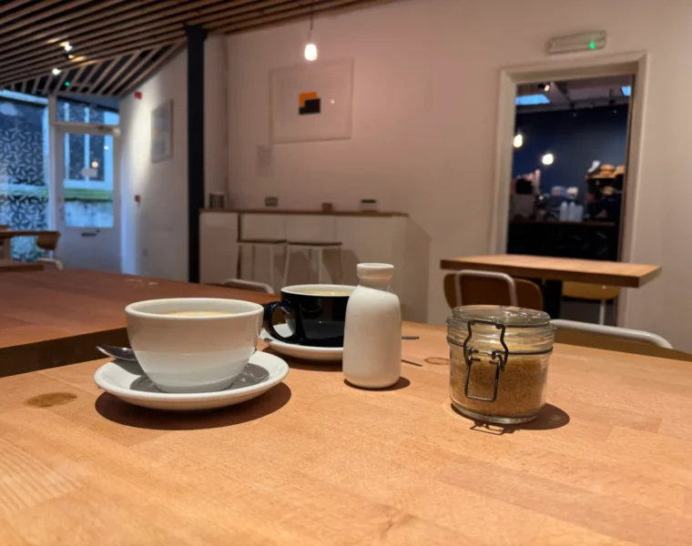 Two coffee cups on a table at Bread Source in Norwich