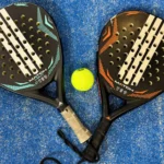 Padel rackets and a ball on the ground