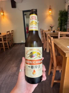 Hand holding a bottle of Kirin Ichiban