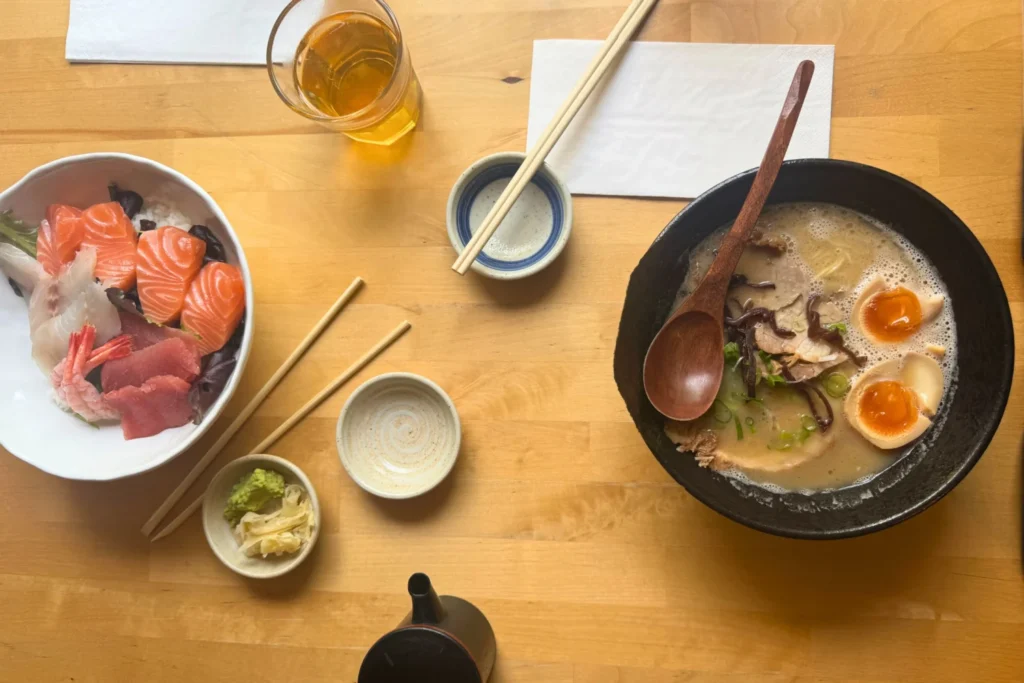 Sashimi and ramen on a table at Soyokaze in Norwich